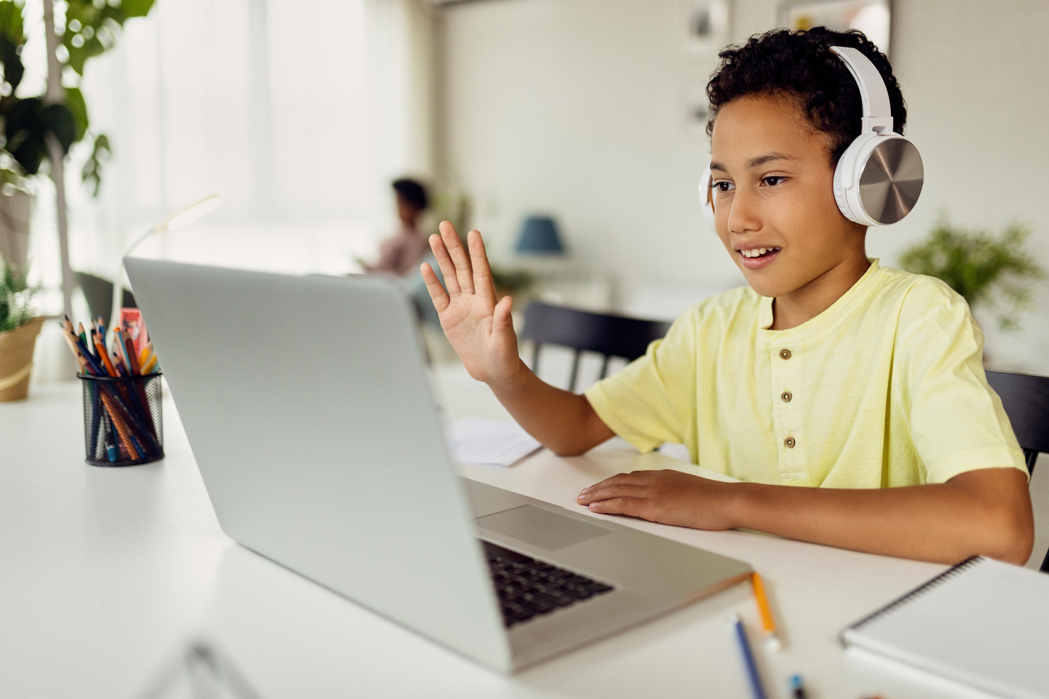 Boy with headphones at laptop