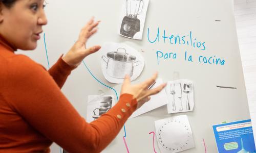 10 Tips for Using Students' Home Languages to Support Instruction Teacher showing kitchen utensils in the kitchen