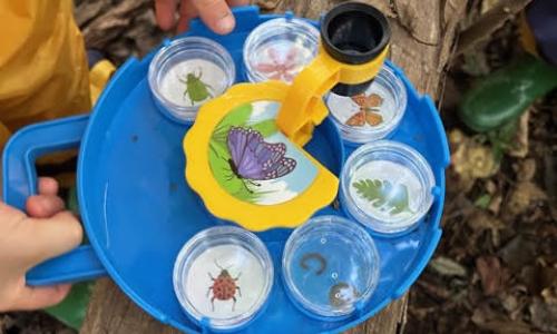 Educating Young English Learners: Lessons Learned from the Falls Church McLean Children's Center Child holding tray outside