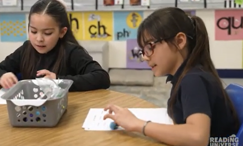 Two students worknig at a desk