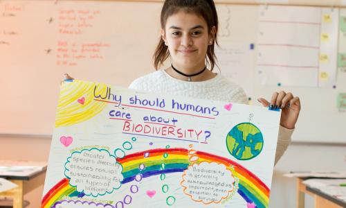 Student with biodiversity poster