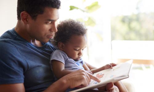 Father and baby reading
