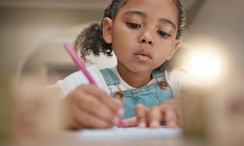 Young girl writing