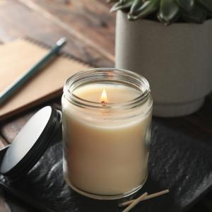 Candle with plant and notebook