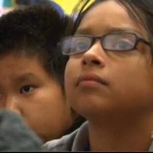 Girl looking up to someone off camera.