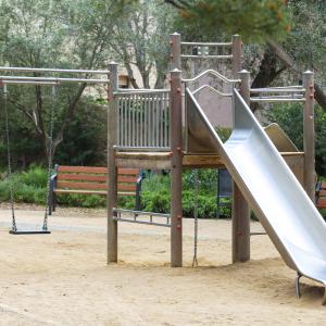 An empty playground with a slide.