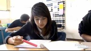 A child looking at a packet of papers on at a table