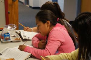 a young girl writing