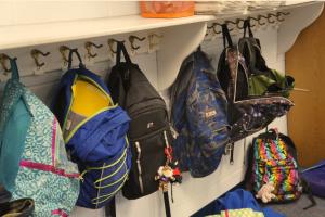 A row of haning backpacks.