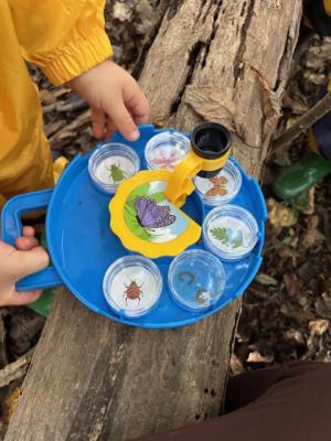 Child holding tray outside