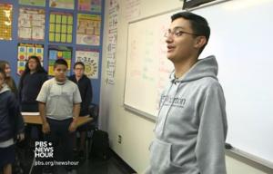 Student speaking in front of classroom