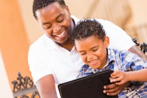 Father and son looking at tablet