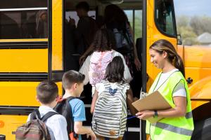 School bus driver greeting students