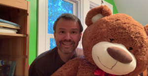 Principal Mark Gaither holding teddy bear