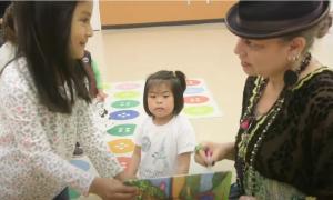 Author Maya Christina Gonzalez signing a book for a girl