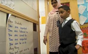 Ms. Alhaiki shows a student the message near her classroom