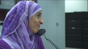 A woman in a hijab talking on the phone.