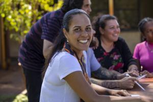 Woman in adult learners class looking at camera