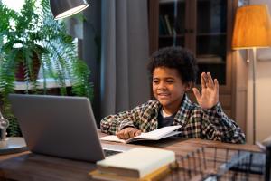 Boy waving to screen