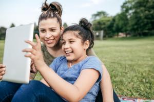 Two kids looking at a tablet computer.
