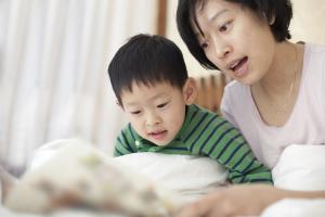Mother and son reading together at home