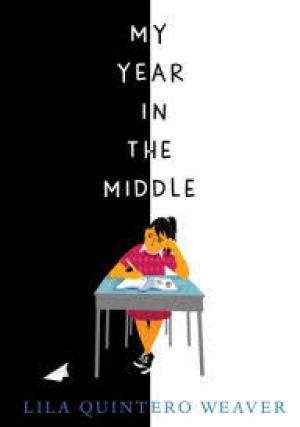 Student sitting at a desk in between black and white background
