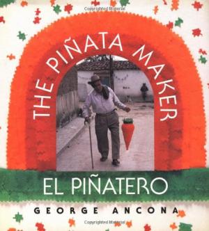 A piñata maker holding a piñata