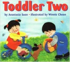 Two toddlers play outside
