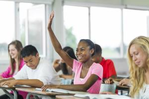 smiling girl raising her hand