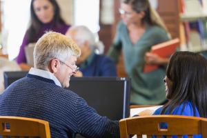 A shot from behind of two adults smiling at each other