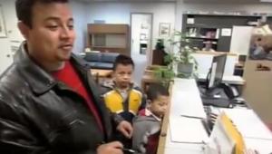 a man with two boys in a school office