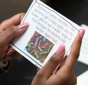 Student holding science card