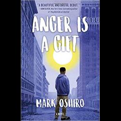 Young man looking up a city street Anger Is a Gift