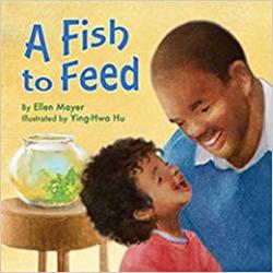 A young boy and his father talk about a fish bowl