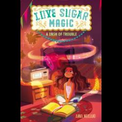 A girl sits in front of a book that magic swirls around