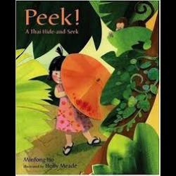 Young girl hiding behind a leaf