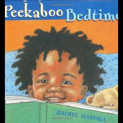 Young child peeking above a book