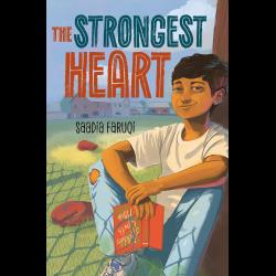 Boy sitting against a tree