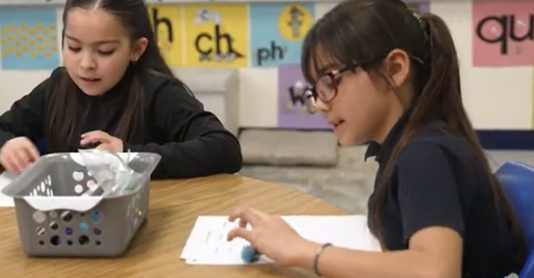 Girls working on phonics lessons