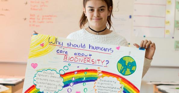 Student holding a poster