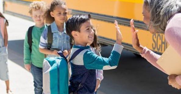 Teacher greeting student