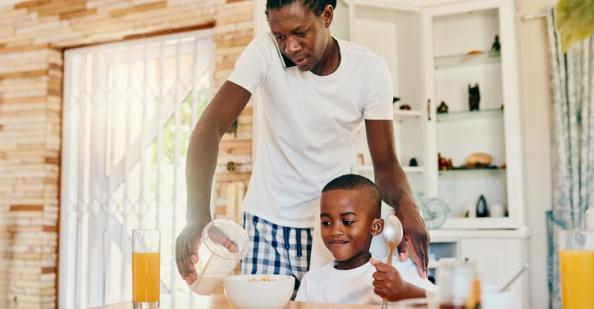 Father pouring juice for son