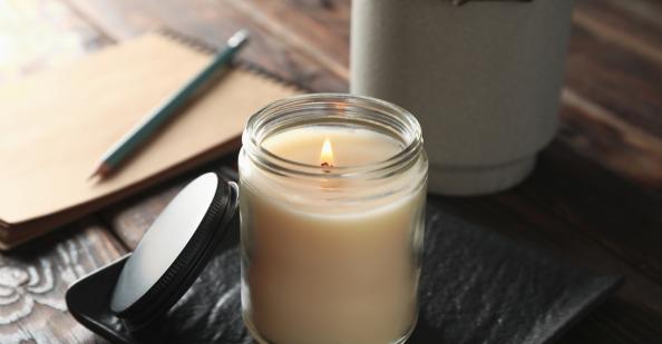 Candle burning on desk