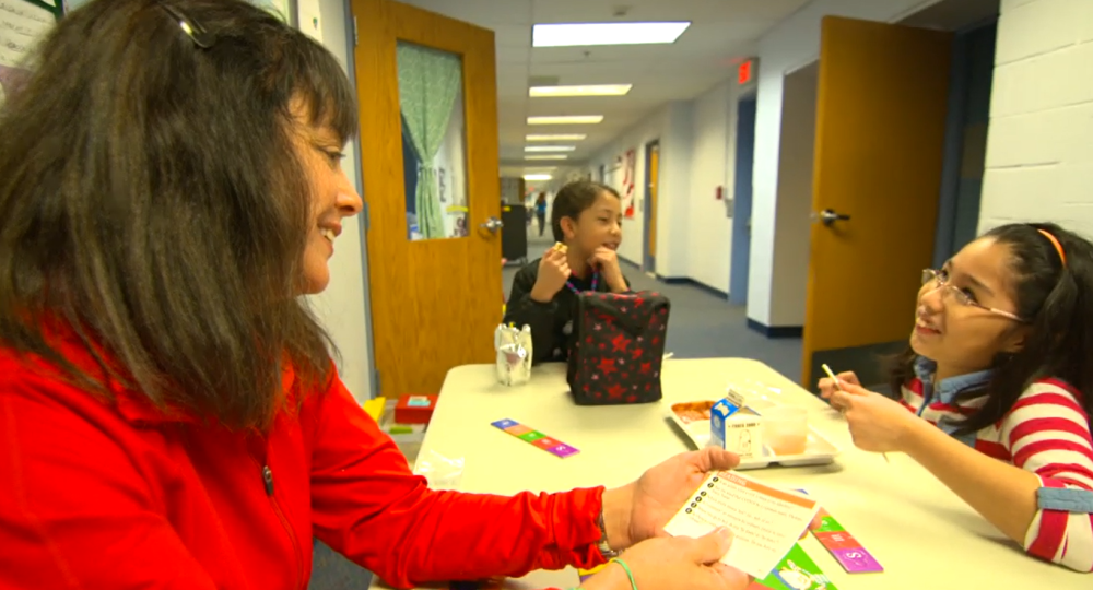 Teacher having lunch with students