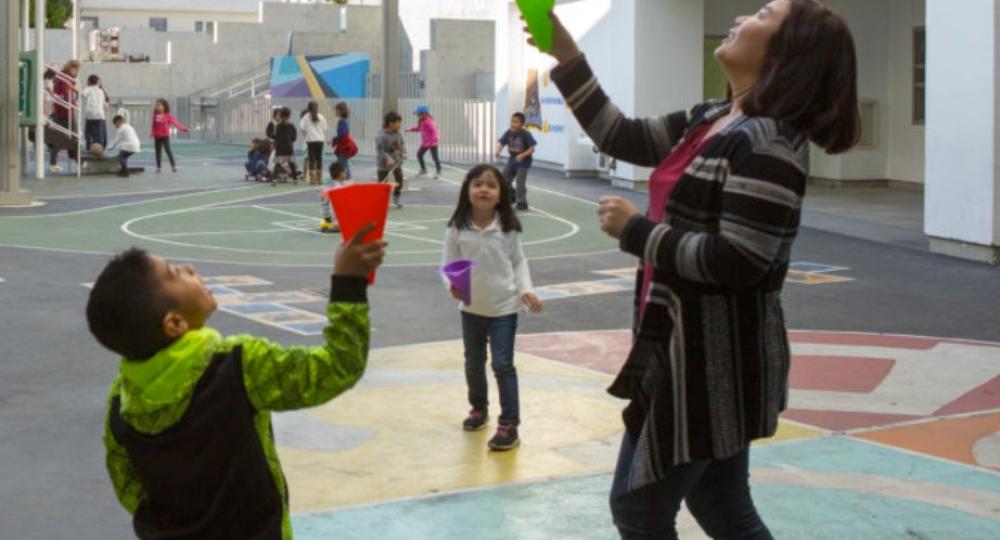 Teacher playing with students outside