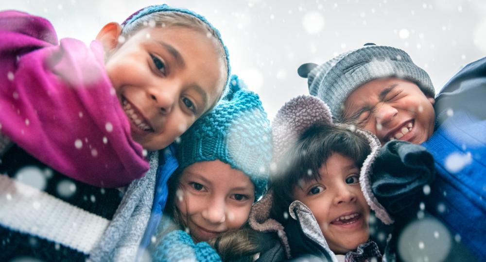 Smiling students huddled in the snow